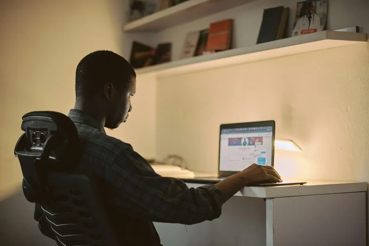 Creative professional working on a laptop in a Nigerian workspace