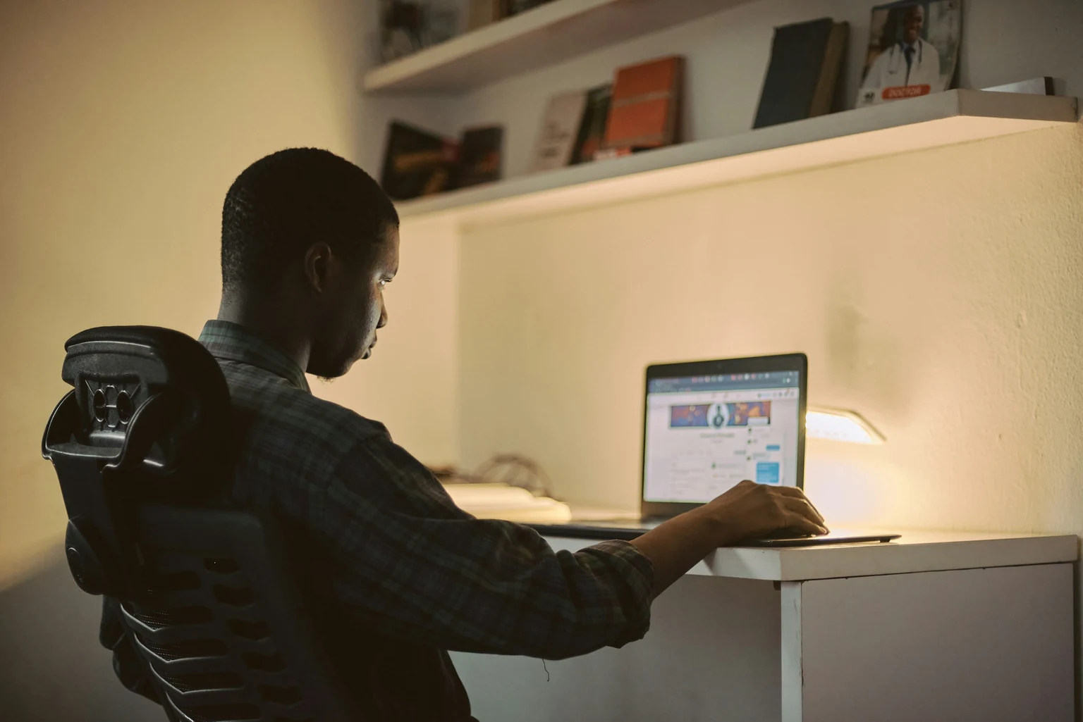 Creative professional working on a laptop in a Nigerian workspace