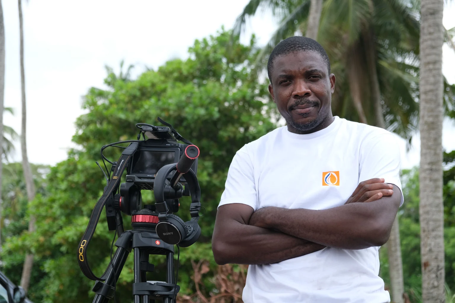 African photographer working with camera equipment outdoors in Abidjan